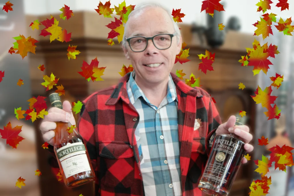 A standholder holding two offerings of their maple syrup whisky