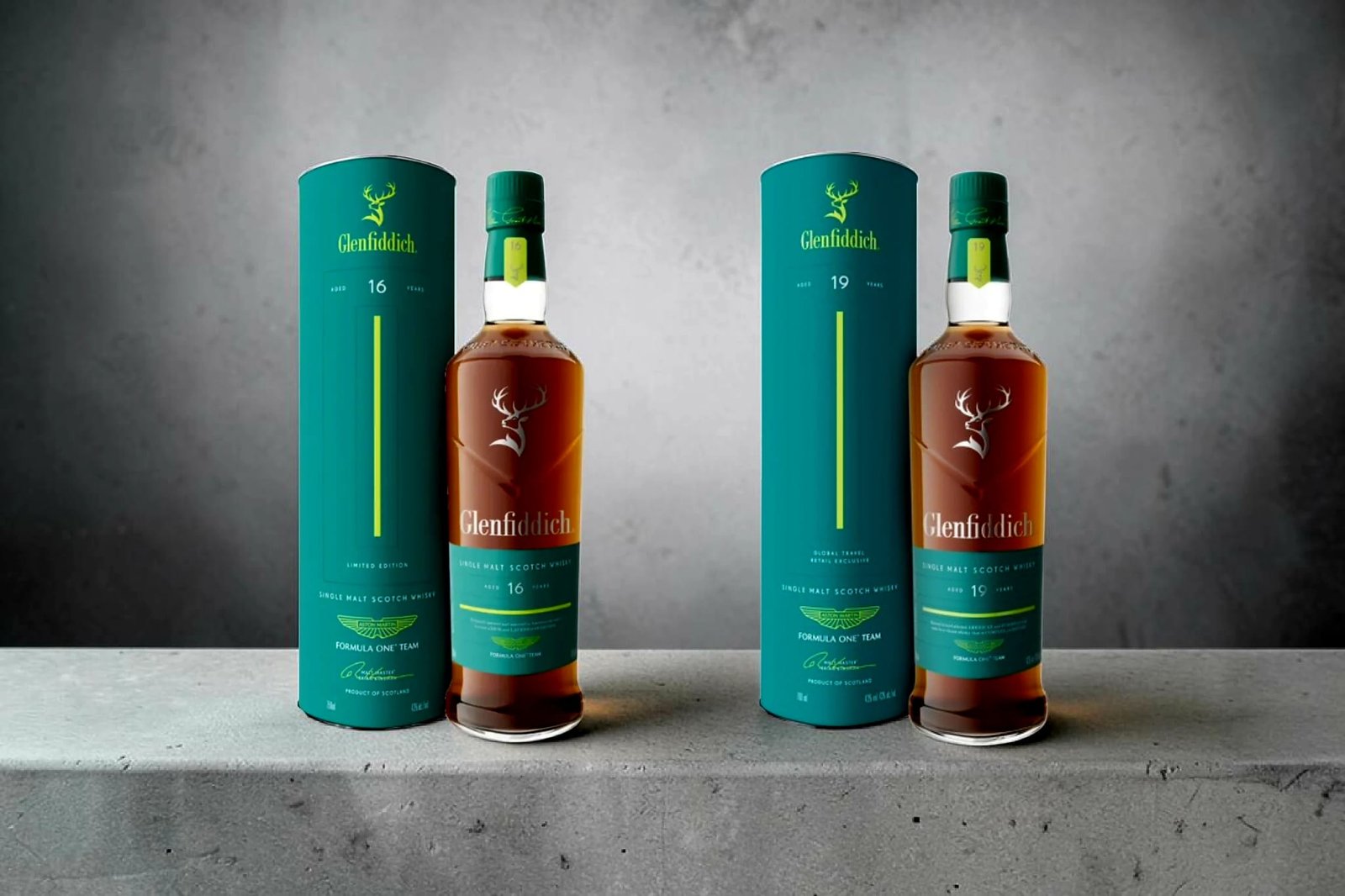 Two Glenfiddich single malt Scotch whisky bottles, aged 16 and 19 years, displayed side by side with matching green presentation tubes from the Glenfiddich Formula One Team limited edition series.