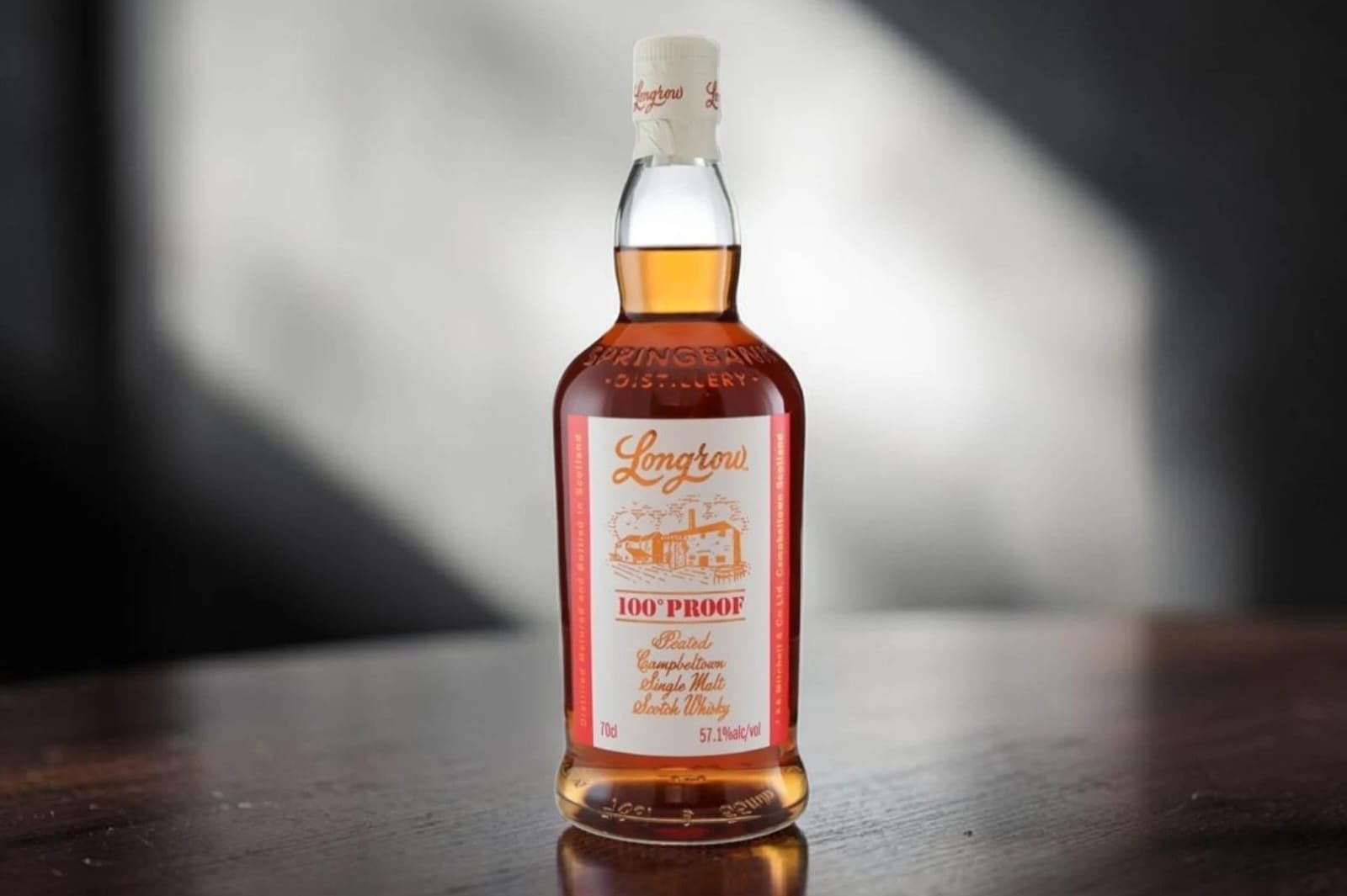 Longrow 100 Proof whisky bottle beside a dram glass during a Longrow 100 Proof Review on Dram1