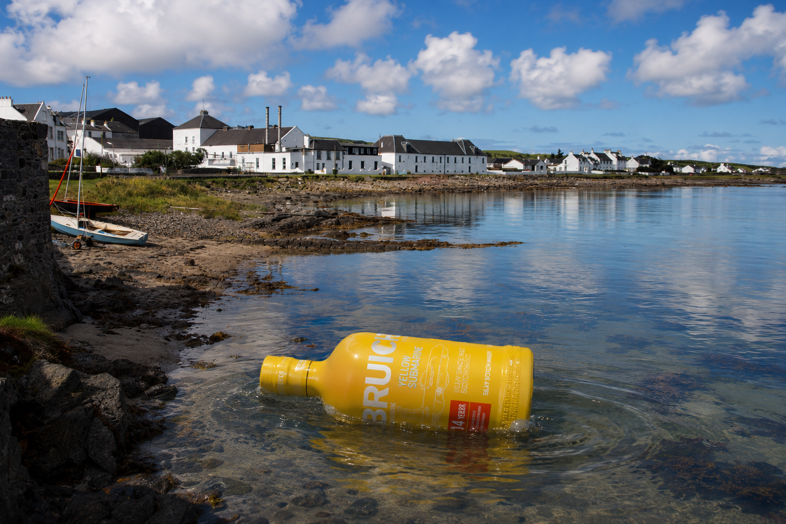 Bruichladdich Yellow Submarine 2026 bottle floating in Loch Indaal in front of Bruichladdich Distillery during Rock'ndaal festival on Islay